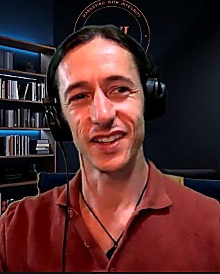 Fran Callado, host of the Marketing with Integrity podcast, wearing headphones on set.
